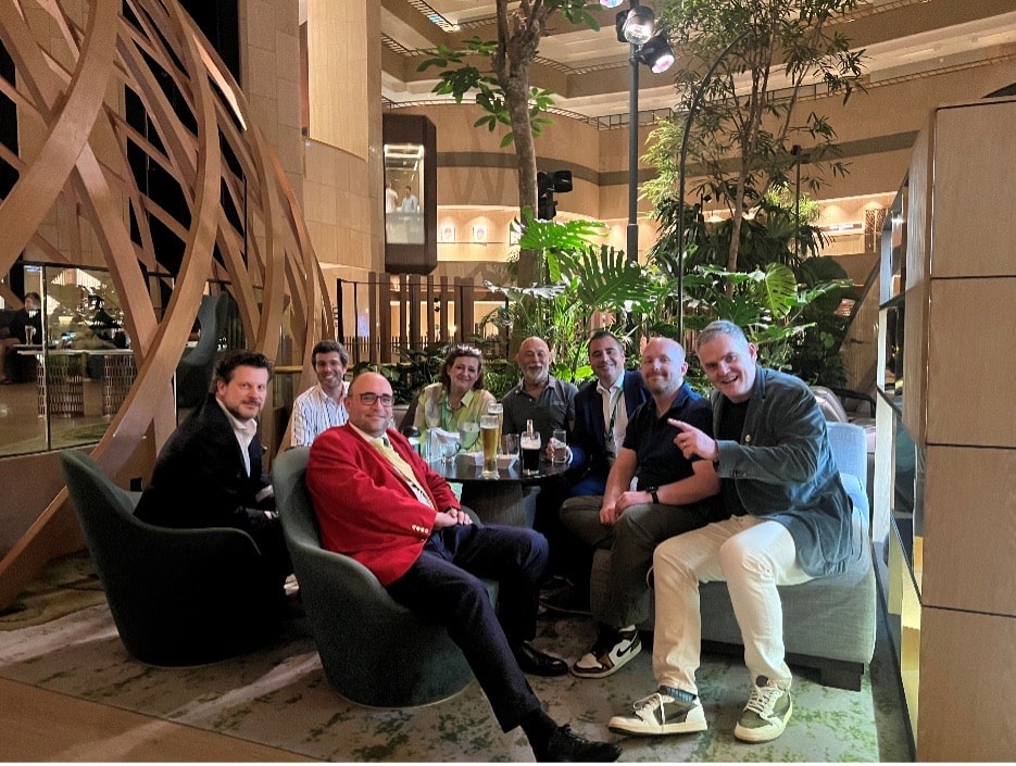 Business people sitting around a table having drinks.