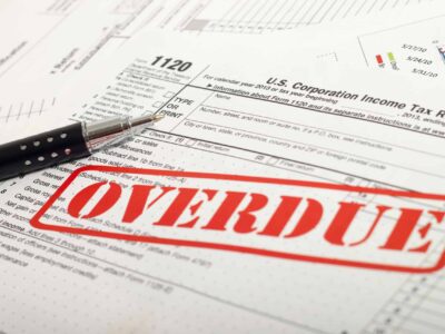 IRS tax forms stamped with "OVERDUE" in red ink