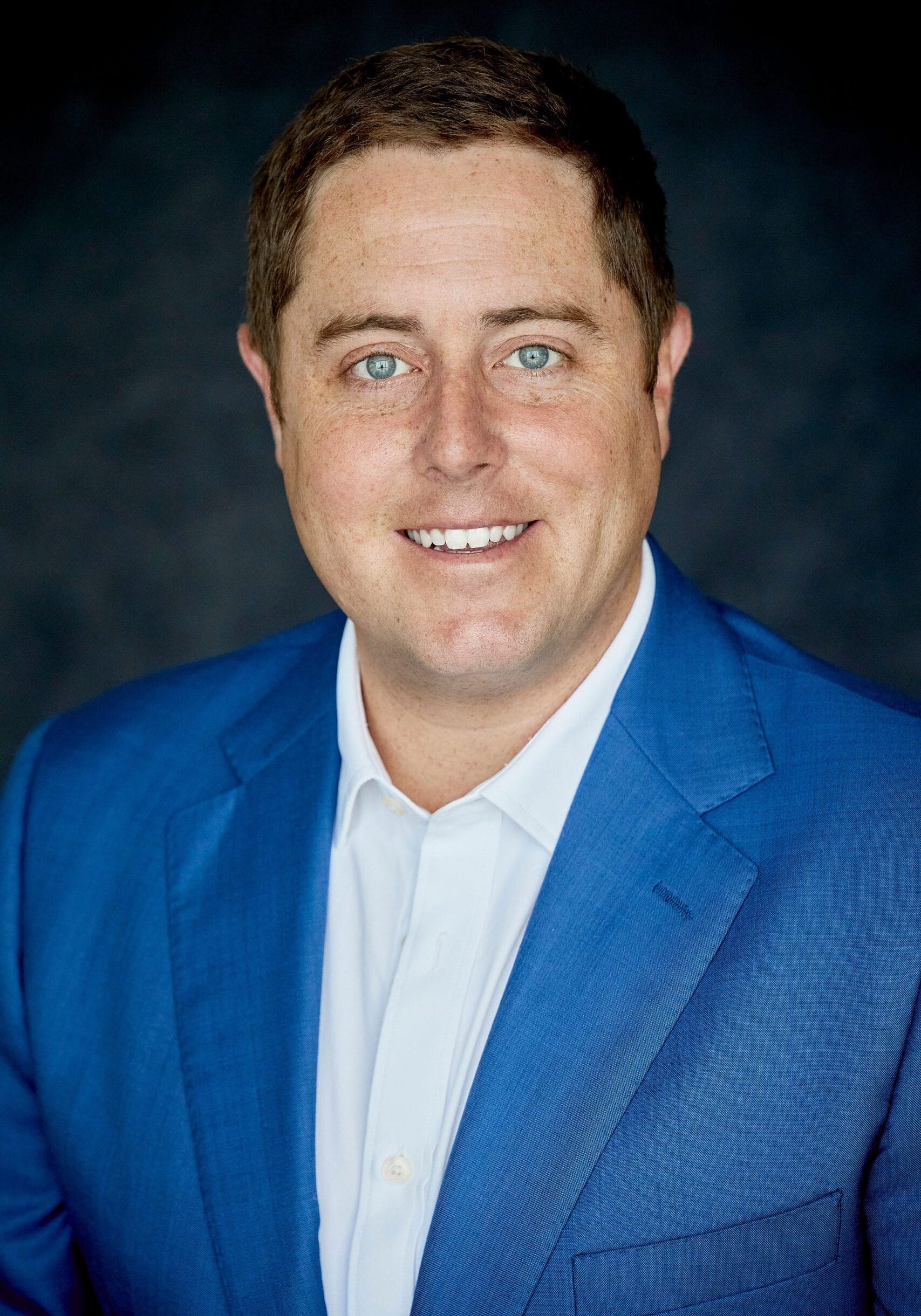 Charles Christensen headshot in navy blue suit