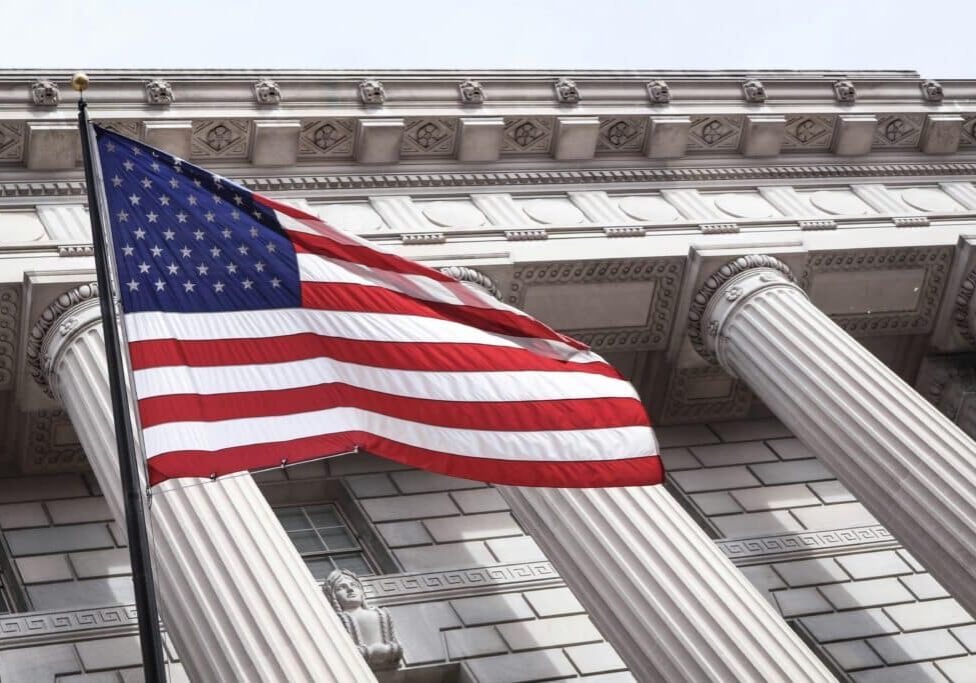 American flag in front of a courthouse.