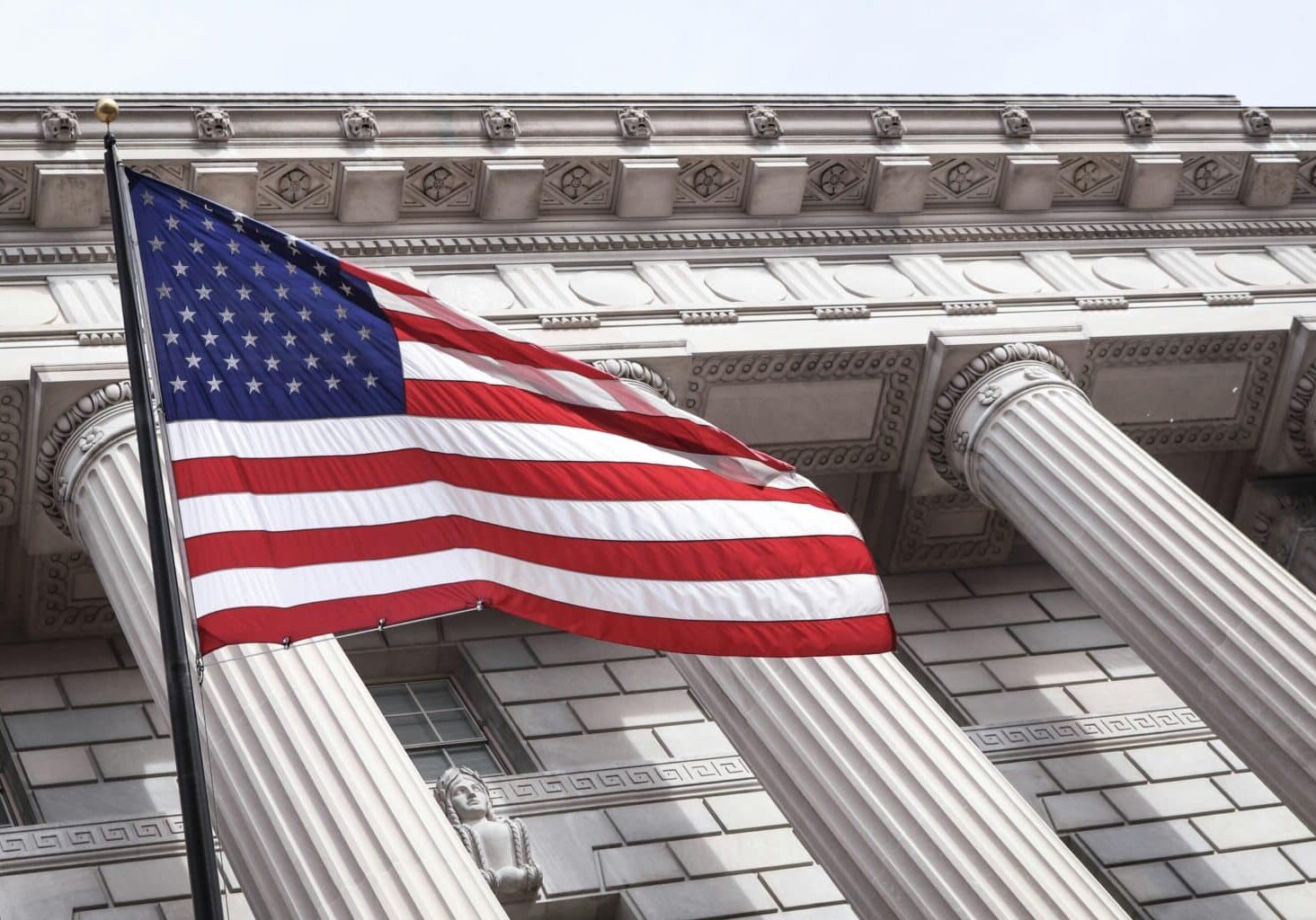 American flag in front of a courthouse.