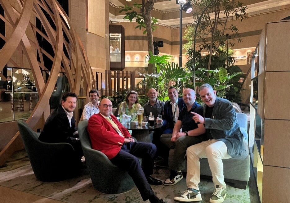 Business people sitting around a table having drinks.