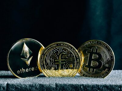 three bitcoins sitting on top of a table